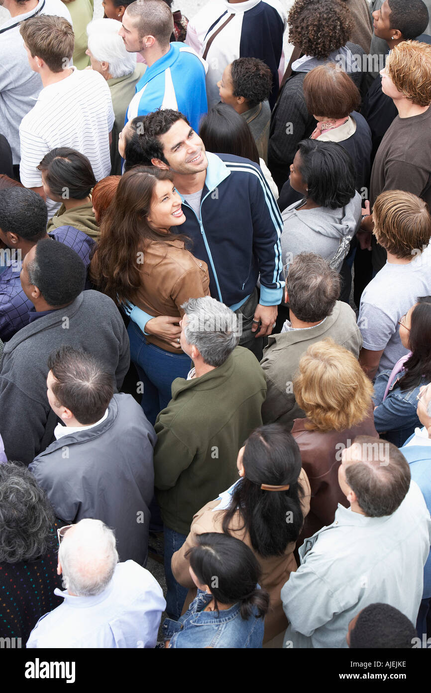 Couple facing the other way to rest of crowd, elevated view Stock Photo
