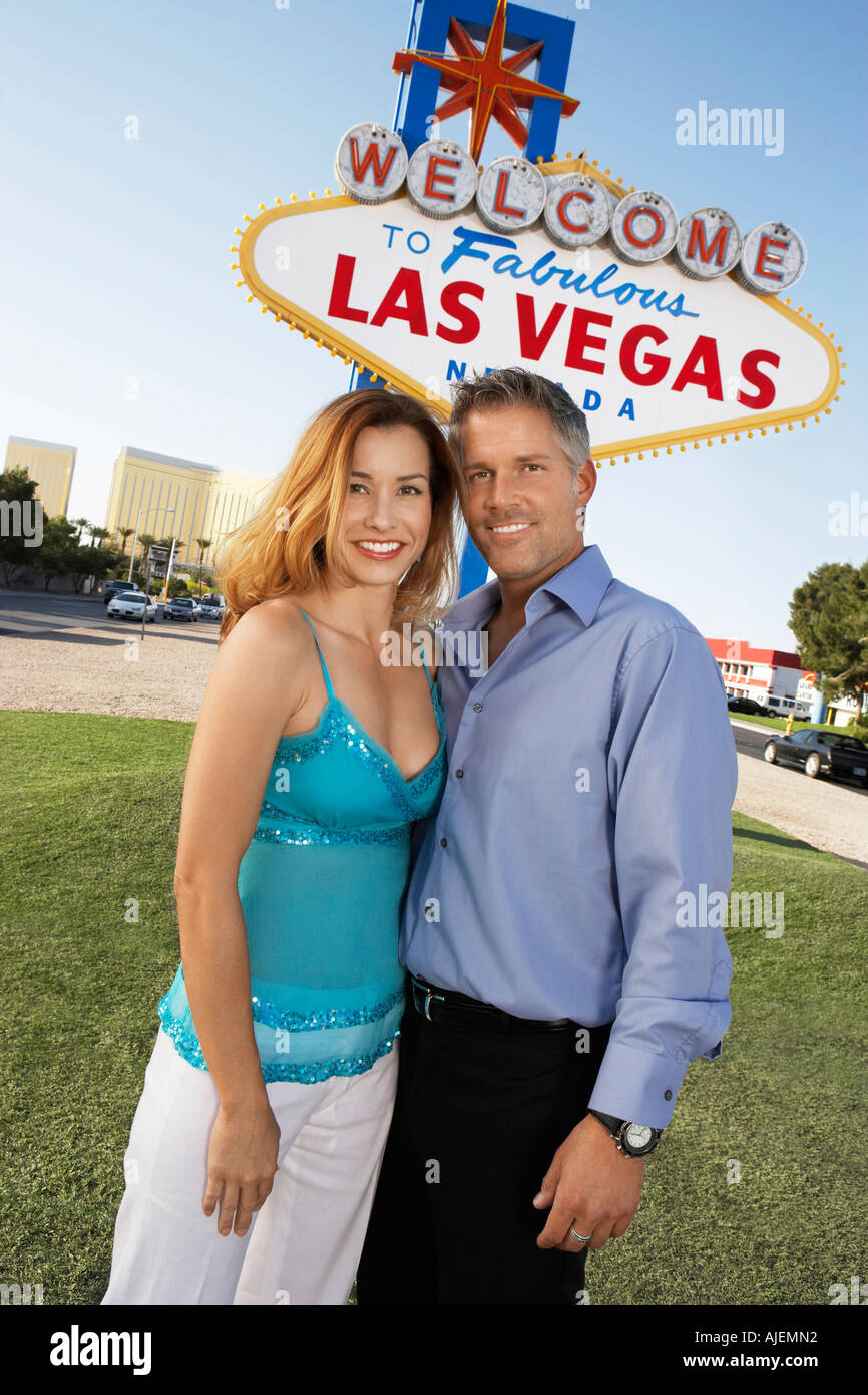 Couple in front of Welcome to Las Vegas sign, portrait Stock Photo