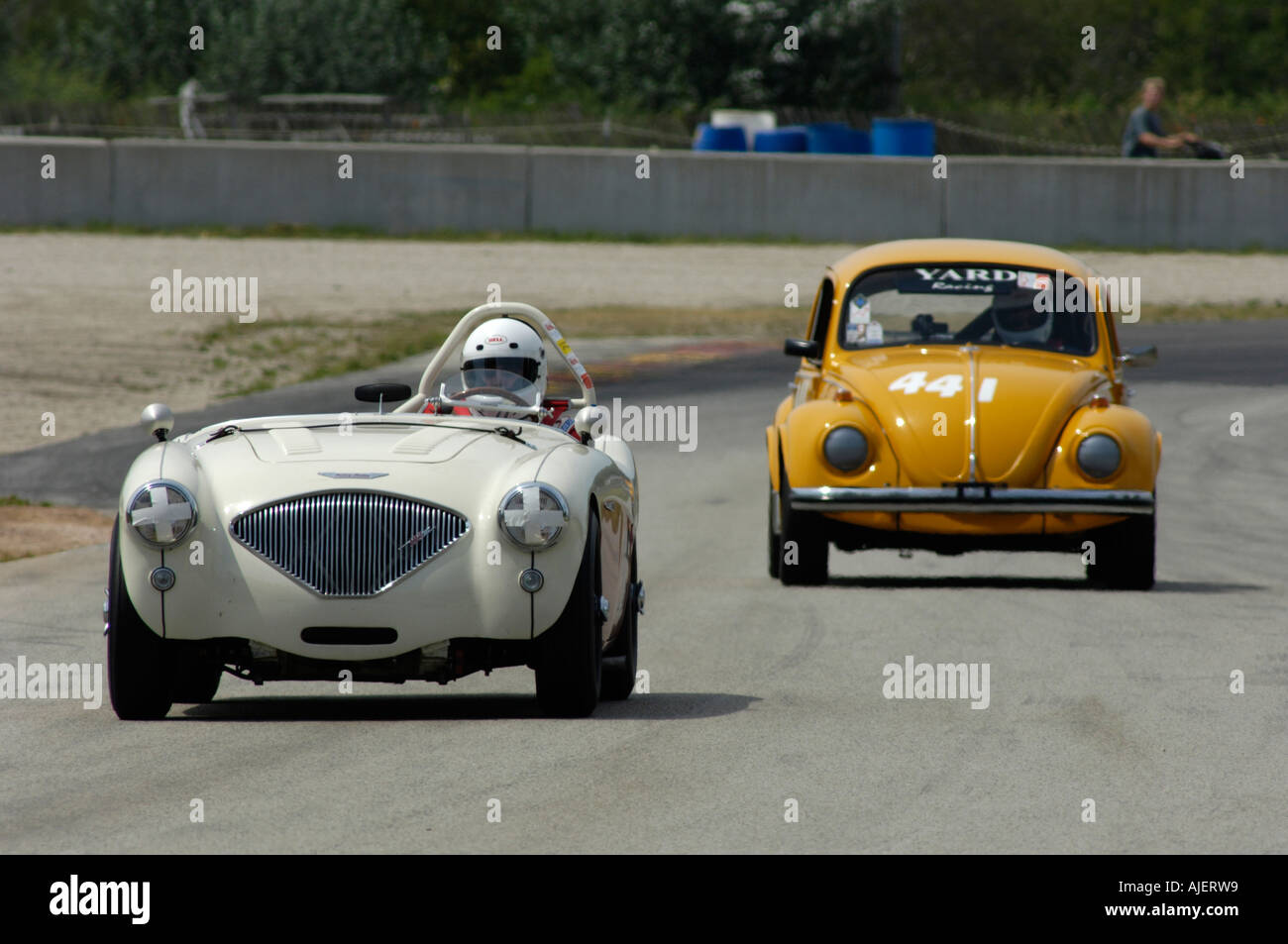 Bruce Earl races his 1954 Austin Healey 100M followed by a 1969 Volkswagen Beetle at the 2006 Stock Photo