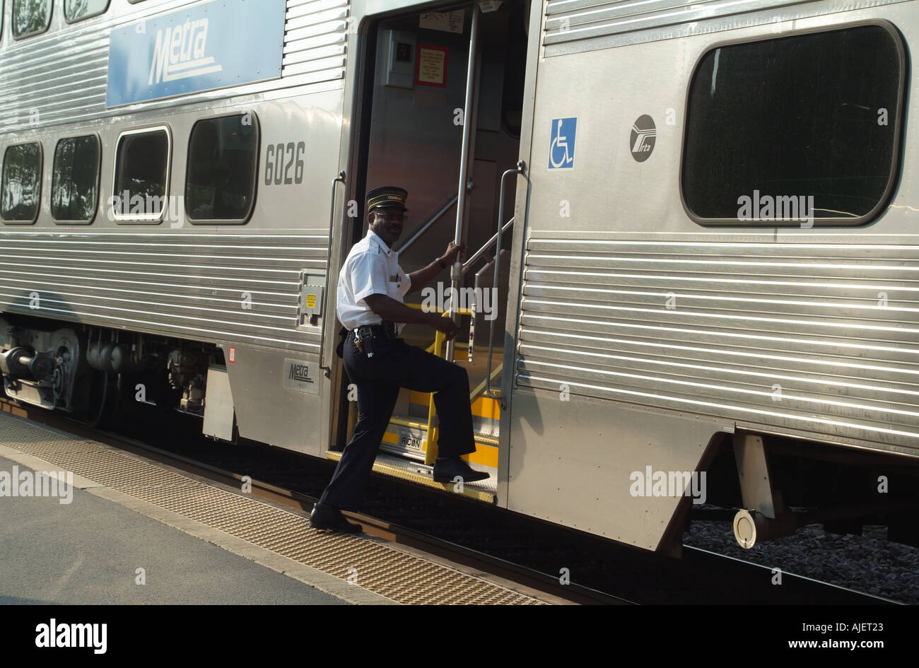 Conductor boards his METRA train at Wheaton near Chicago Illinois USA Stock Photo