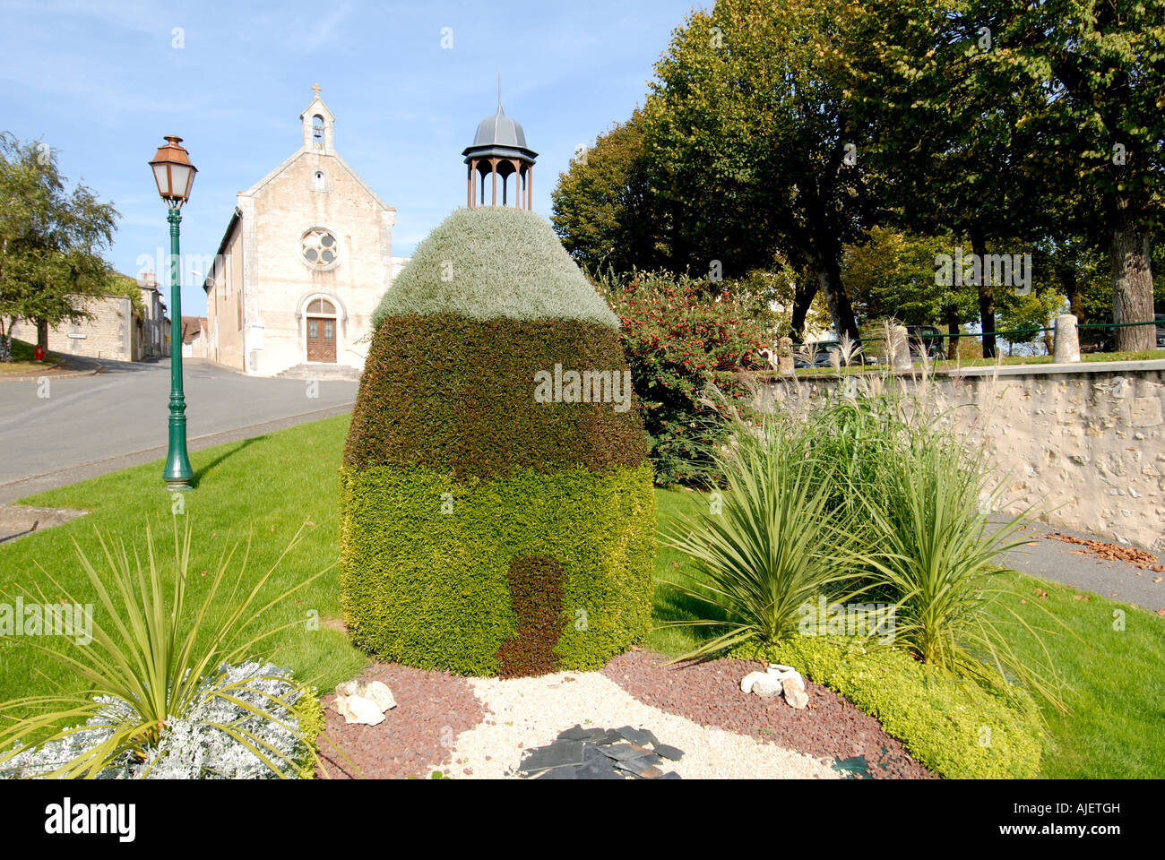 Multi-coloured topiary representation of the Octagon (XIIth C funeral chapel), Montmorillon, Vienne, France. Stock Photo