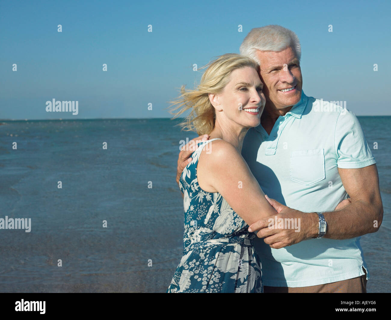 Embraced senior couple on beach Stock Photo