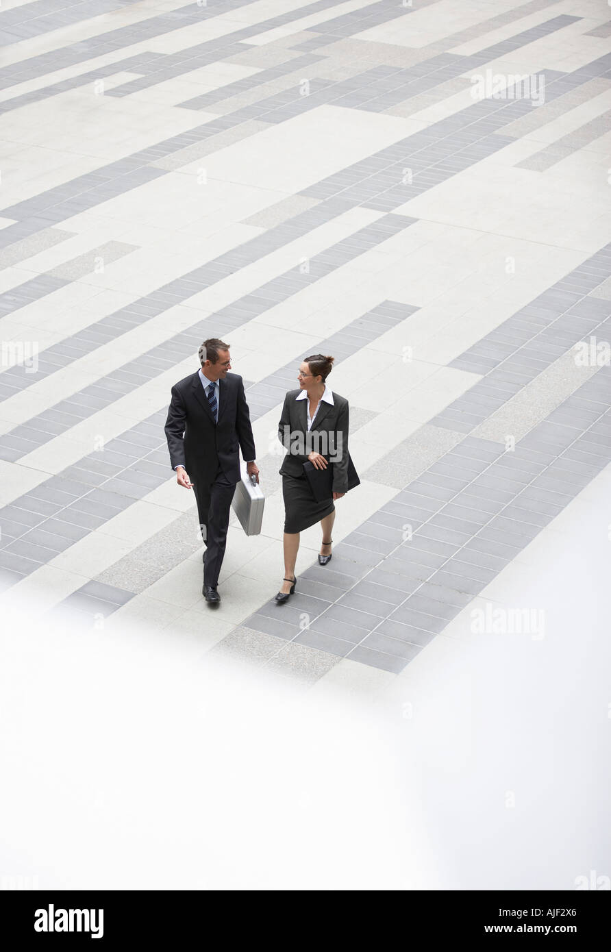 Woman walking across plaza hi-res stock photography and images - Alamy