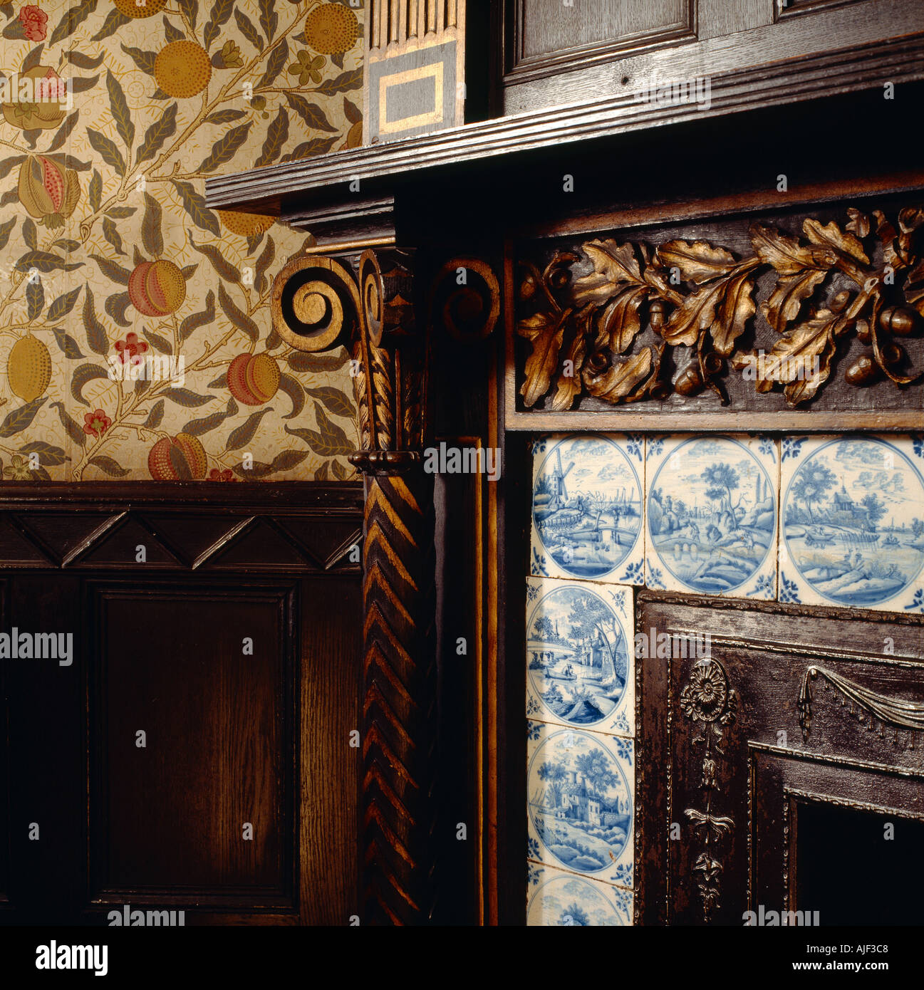 A detailed close up of the corner of the fireplace in the Library at Speke Hall Liverpool Merseyside Stock Photo