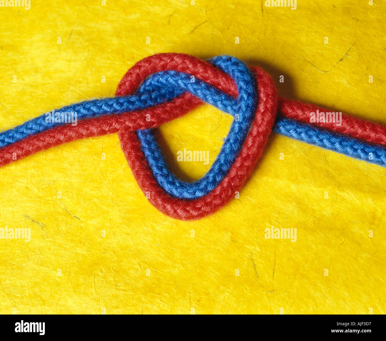 two coloured ropes tied together in a heart shape Stock Photo - Alamy
