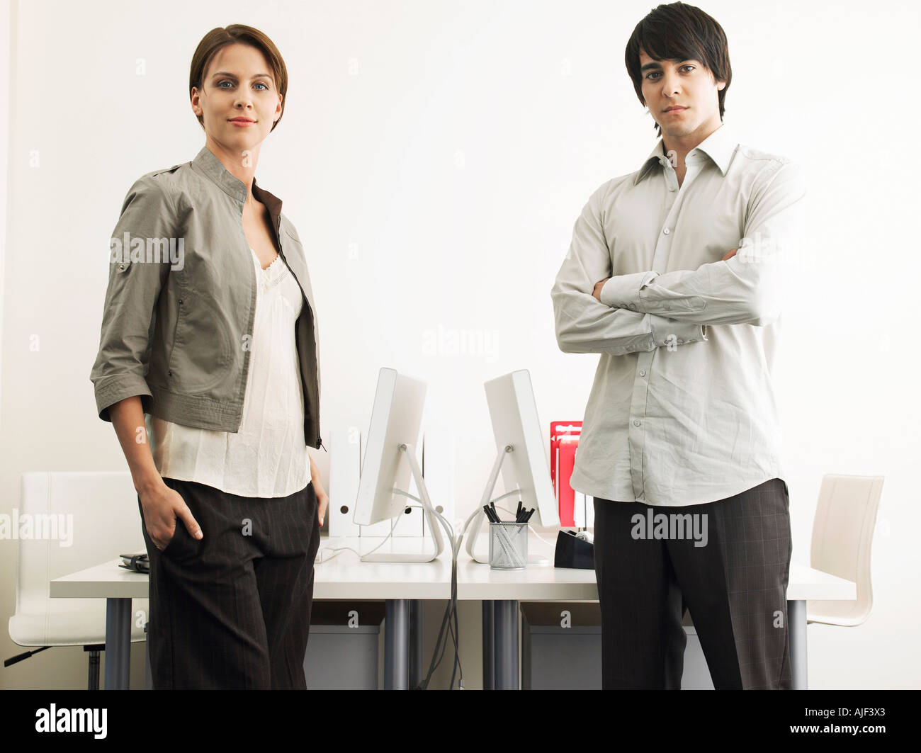 Business Man and Woman standing in office Stock Photo - Alamy