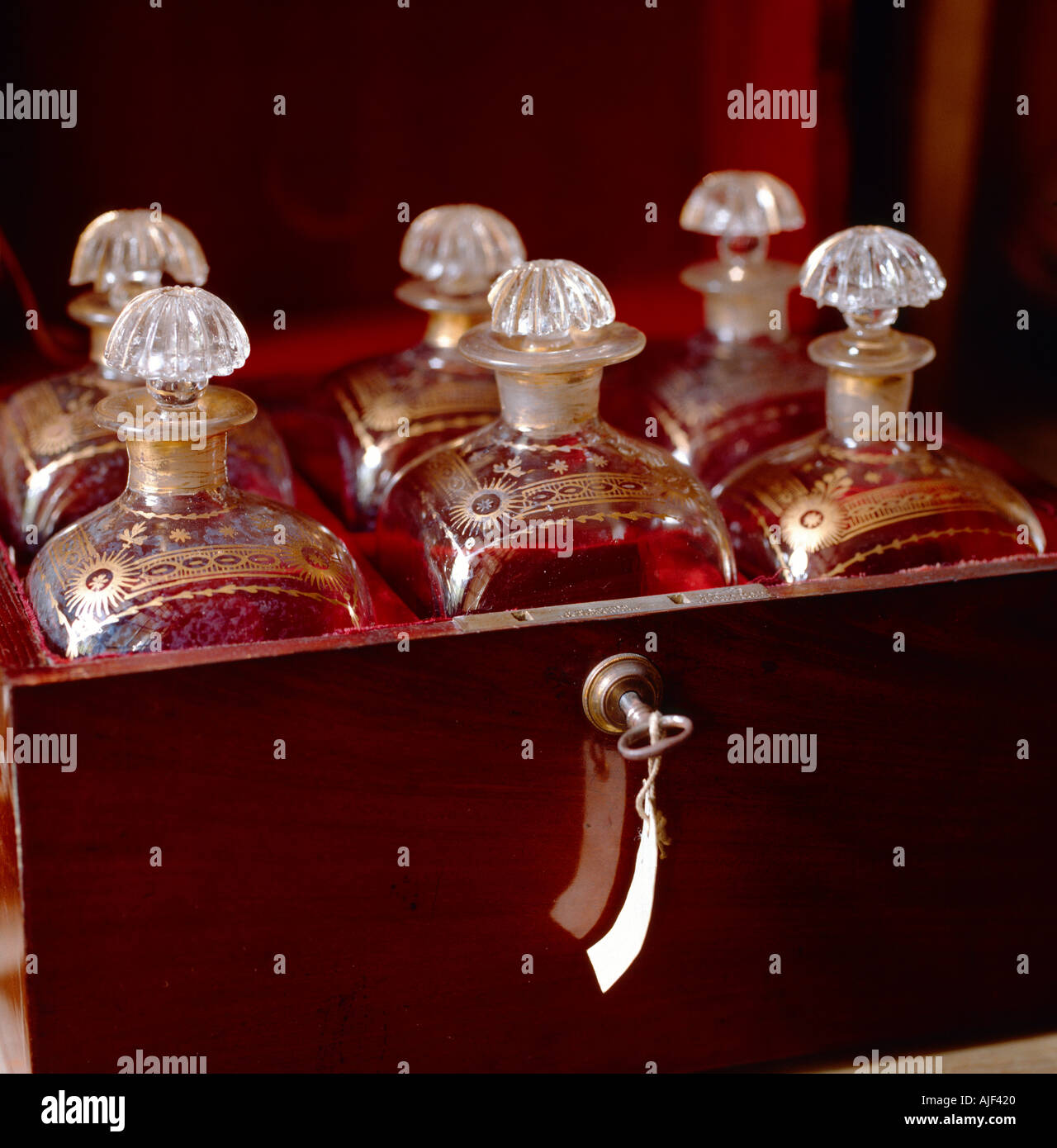 Close up of six decanters in a velvet lined wooden box in the China Closet at Tatton Park Cheshire Stock Photo