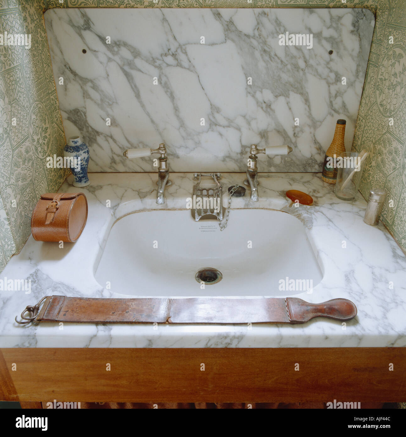 The Bathroom showing a marble enclosed hand basin  at Knightshayes Court Devon Stock Photo