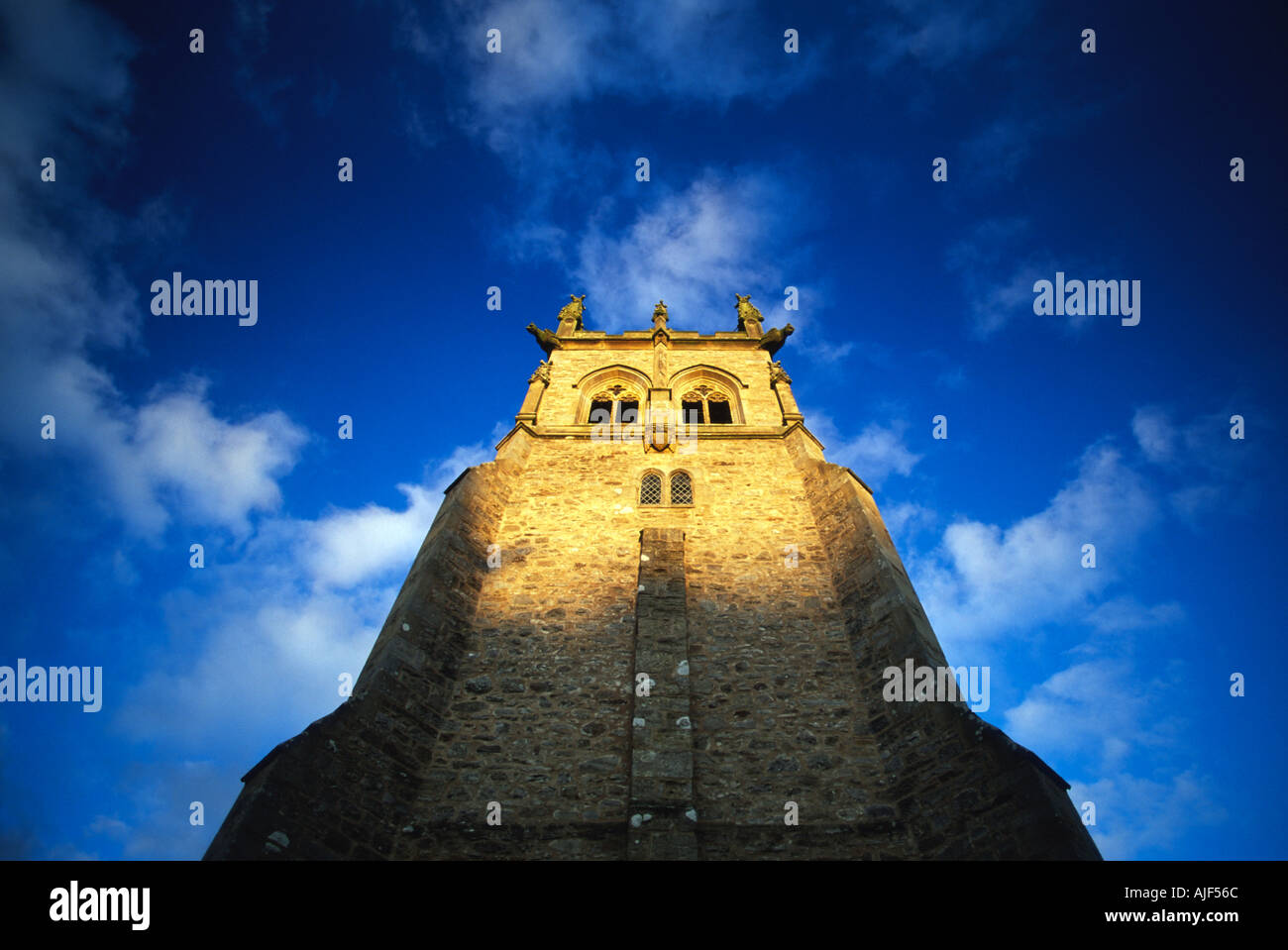 A church tower viewed from below and illuminated by the evening sun in Yorkshire Stock Photo