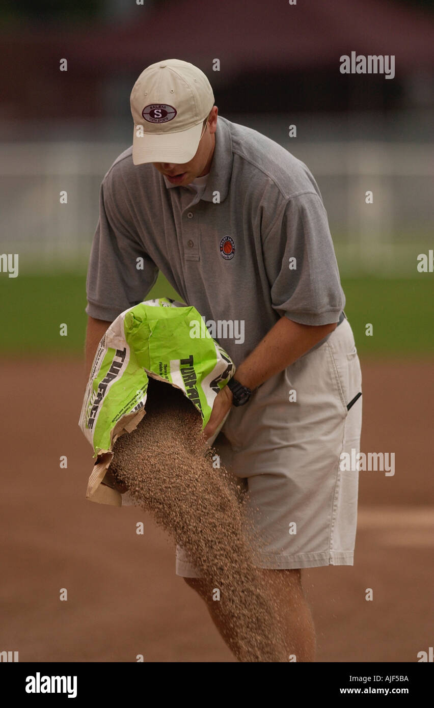 Field crew does maintenance to the baseball field between games  Stock Photo
