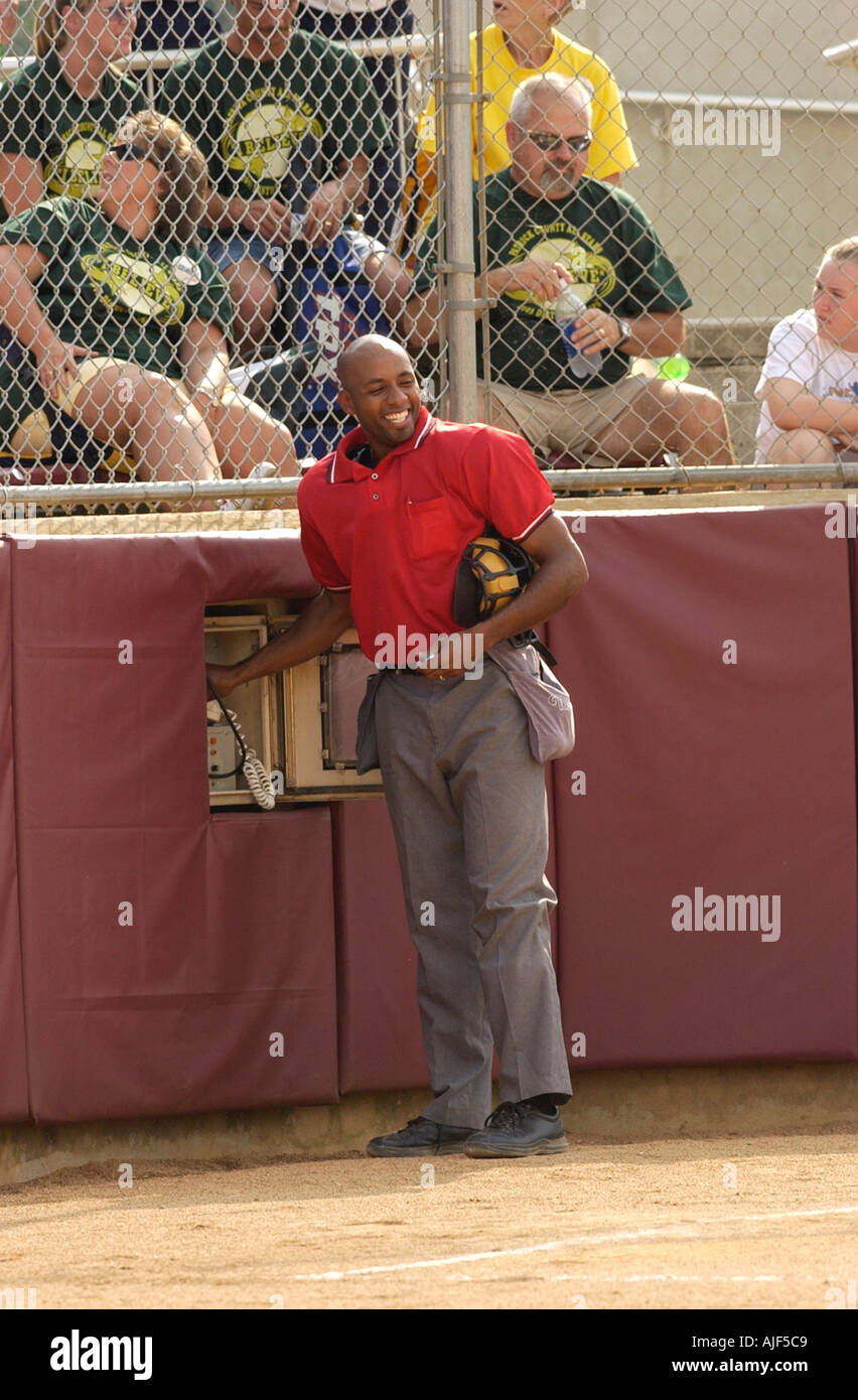 Home plate umpire calls in a substitution on the field phone line  Stock Photo