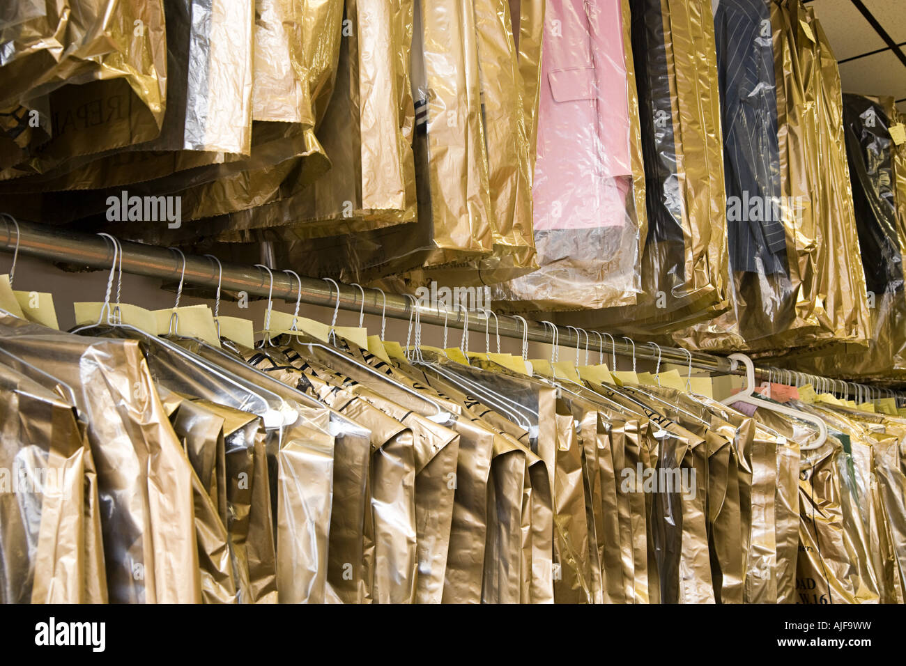 Dry cleaning hanging on a clothes rail Stock Photo