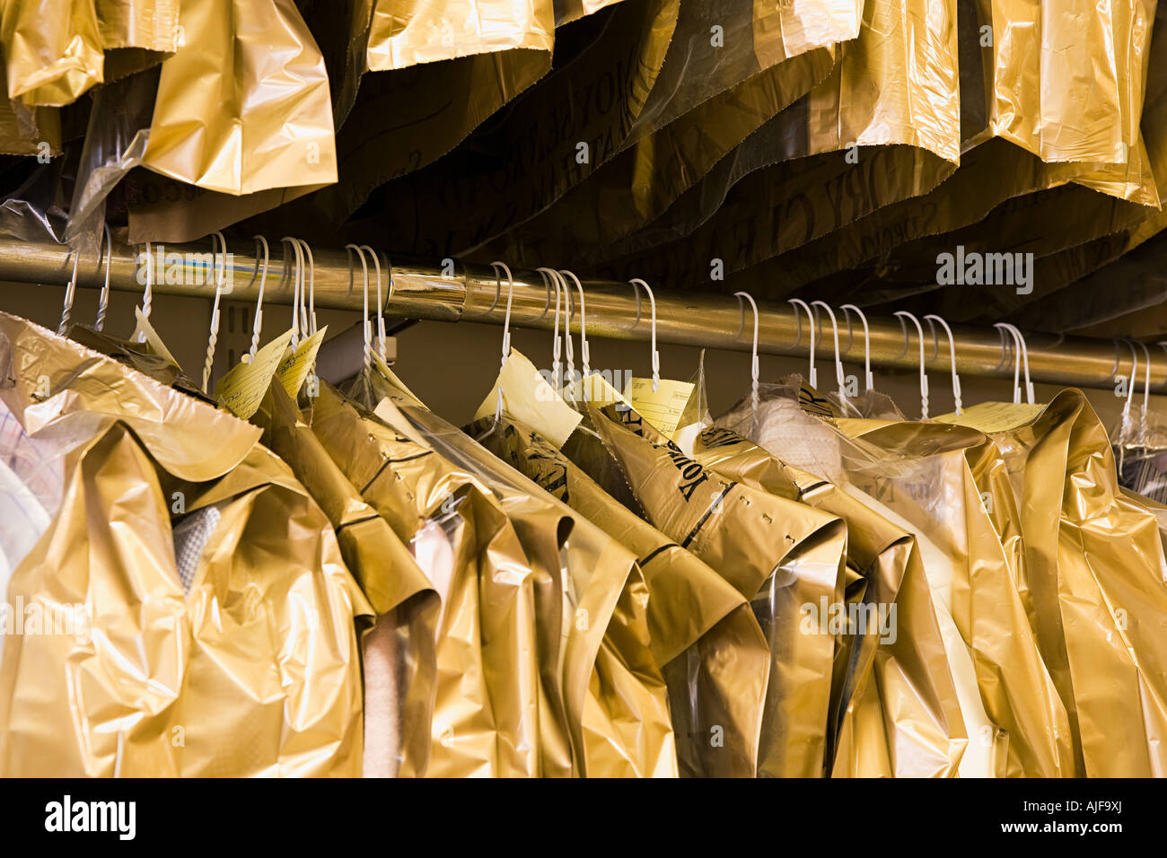 Dry cleaning hanging on a clothes rail Stock Photo