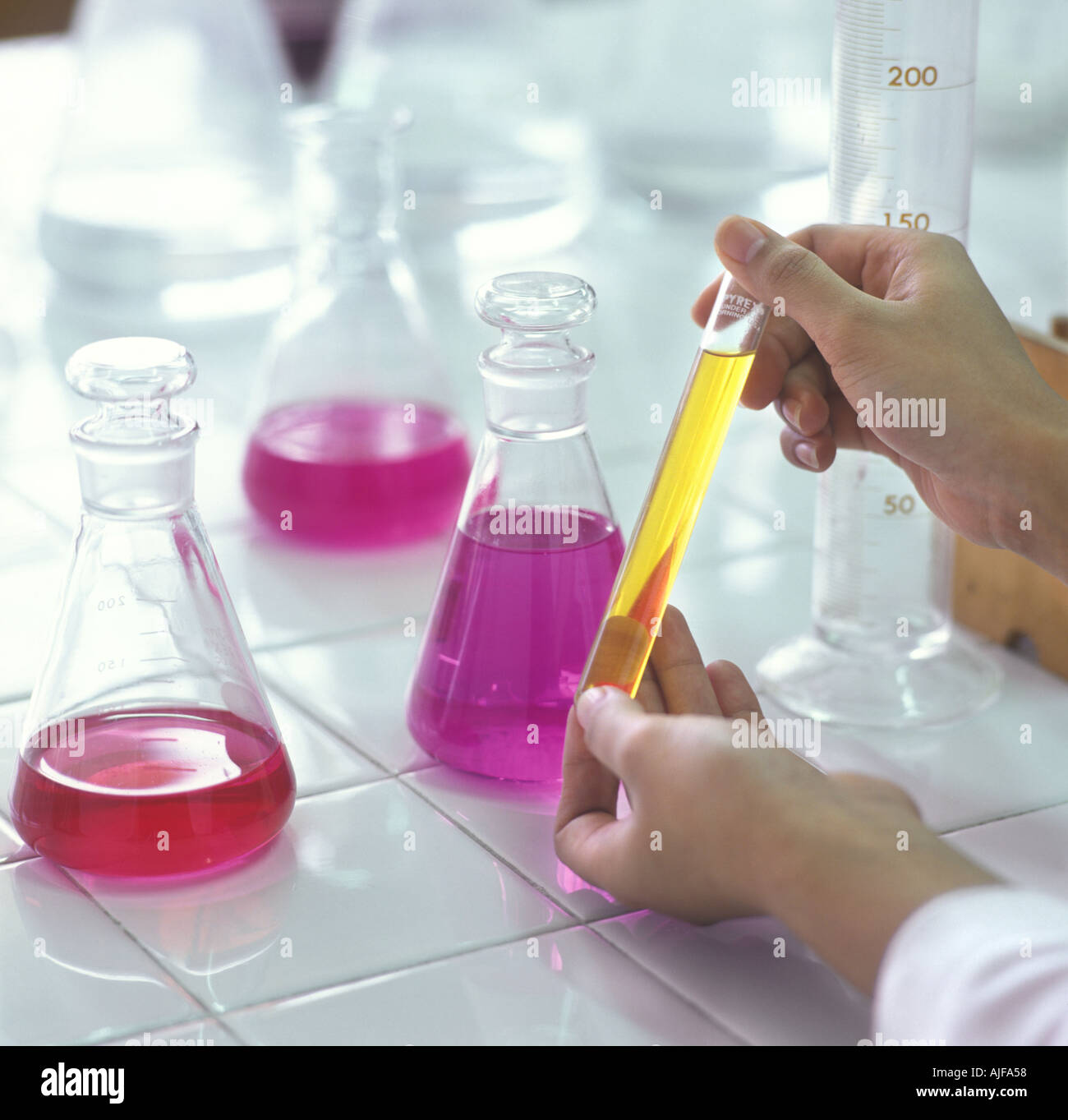 Colorful Beakers In Lab With Technician's Hands Stock Photo Alamy