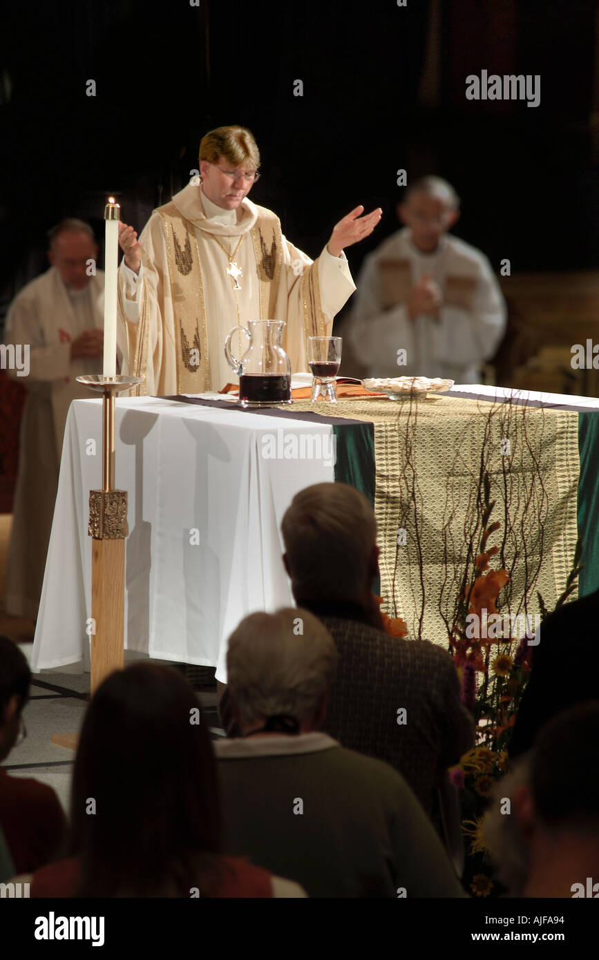 Priest On Altar Celebrating Catholic Mass Stock Photo