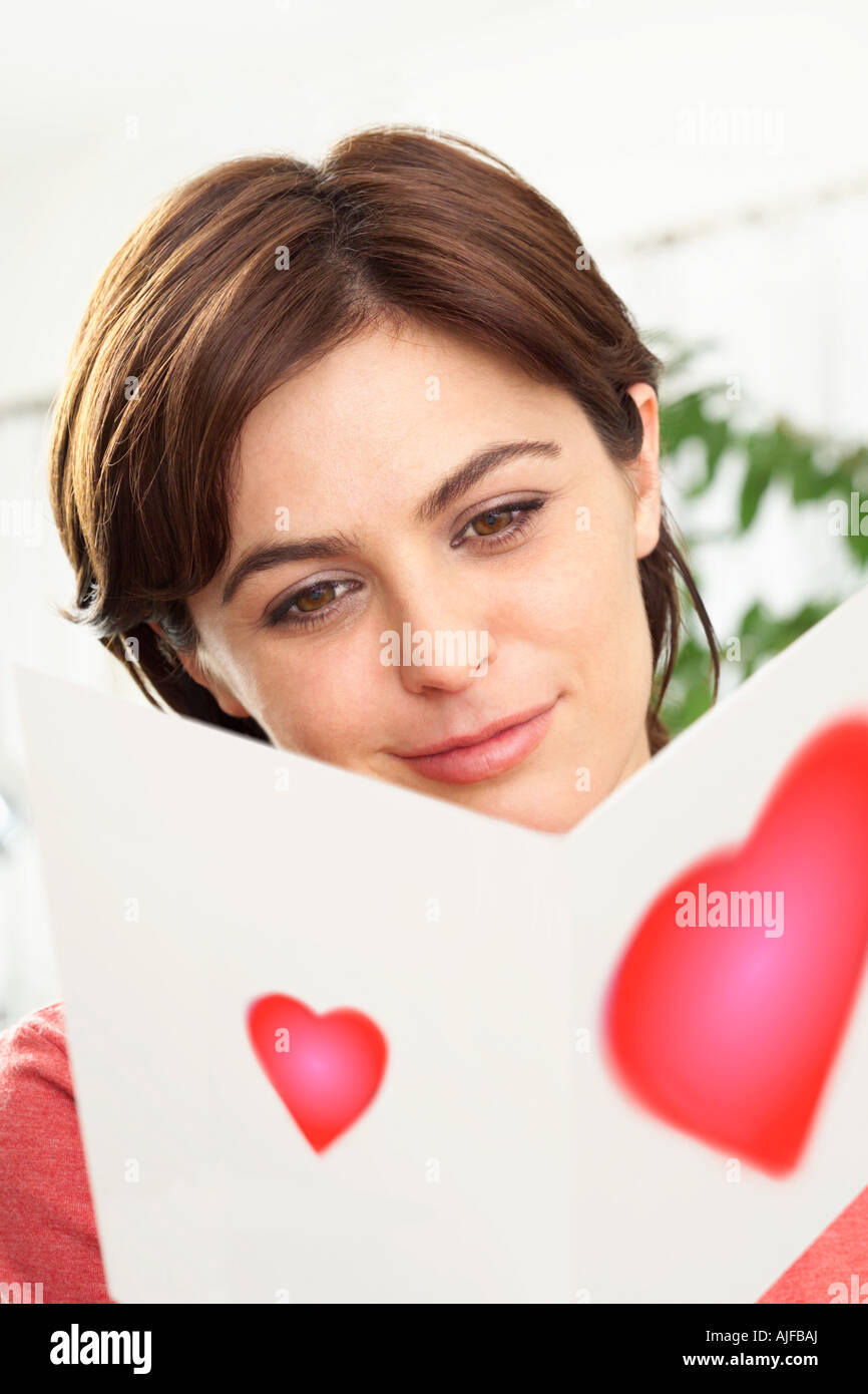 Woman reading a valentines card Stock Photo