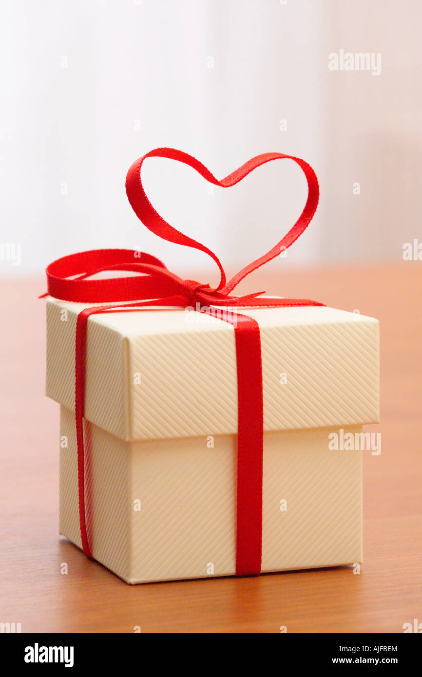 A gift with a heart shaped ribbon on it Stock Photo