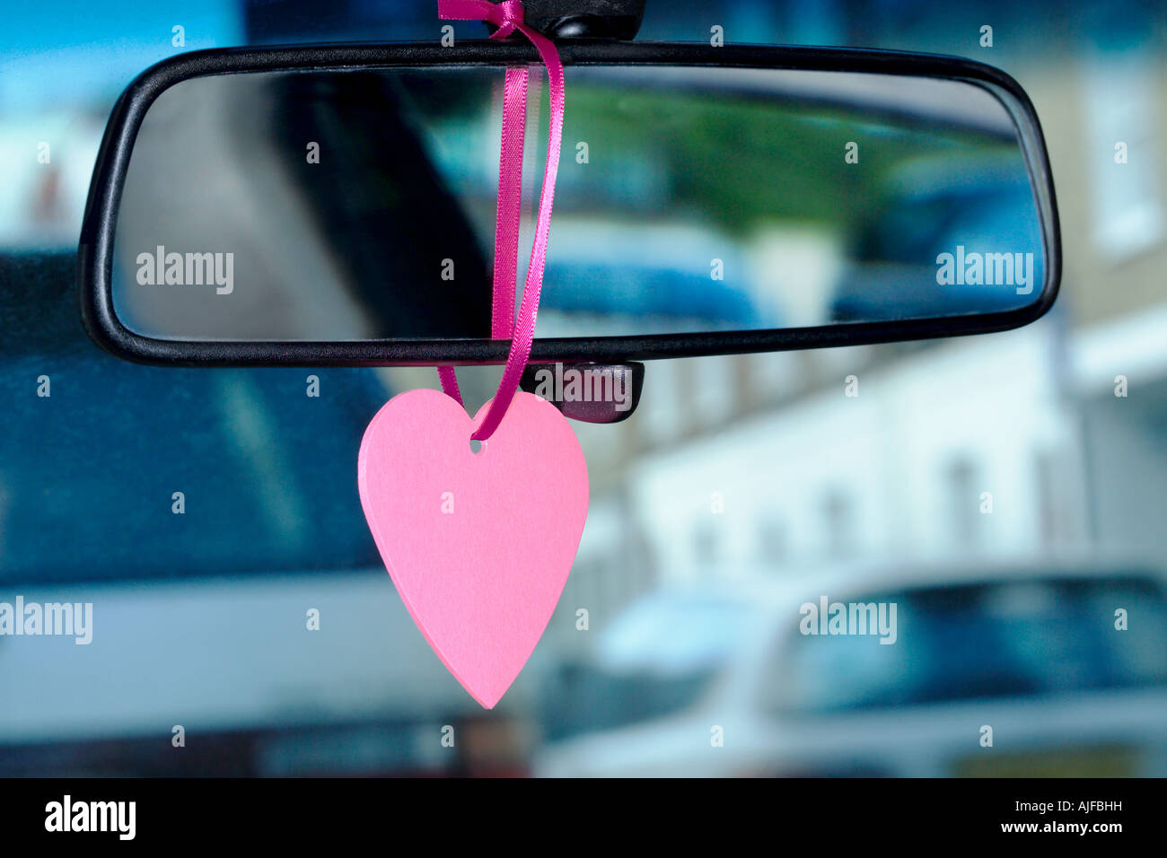 A trinket hanging on a rearview mirror Stock Photo
