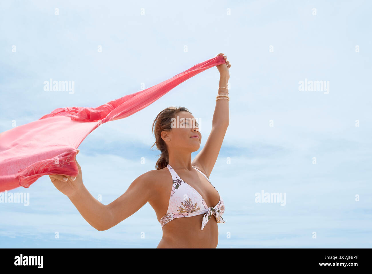 Young woman in bikini holding shawl Stock Photo
