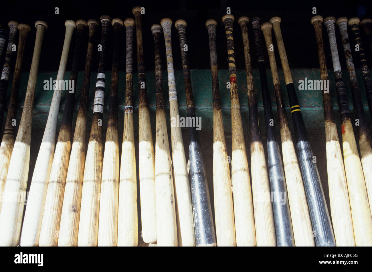 Baseball bats in a row Stock Photo