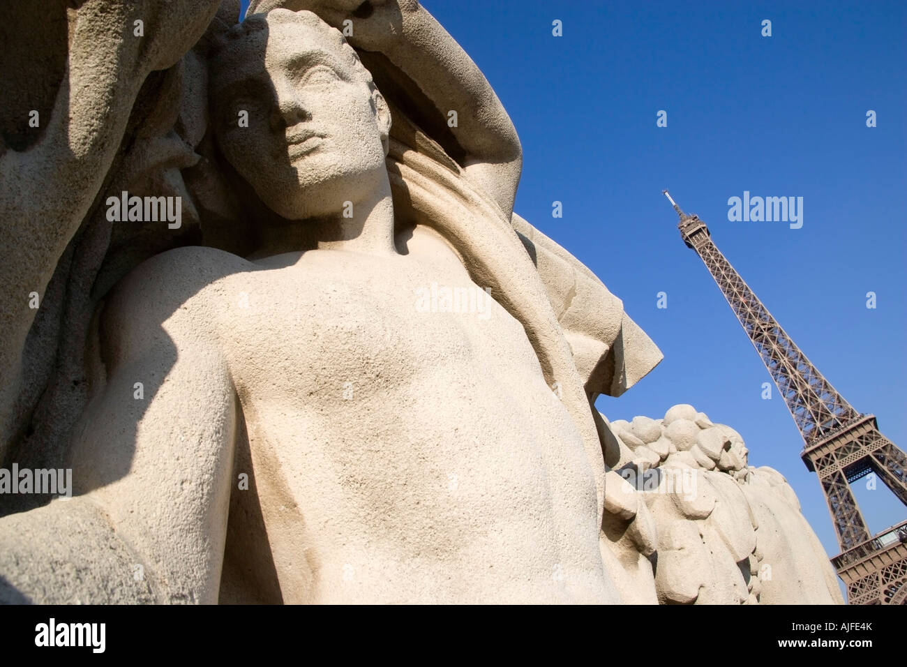 France Ile De France Paris Stone Sculpture Of A Man In The Trocadero Gardens With The Eiffel Tower In The Distance Stock Photo