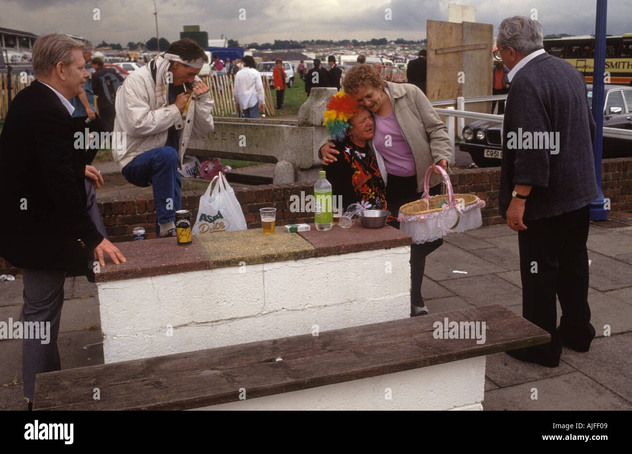Drunk older woman emotional crying too much to drink, being comforted. Derby Day Horse race Epsom Downs Surrey UK. 1985 1980s UK  HOMER SYKES Stock Photo