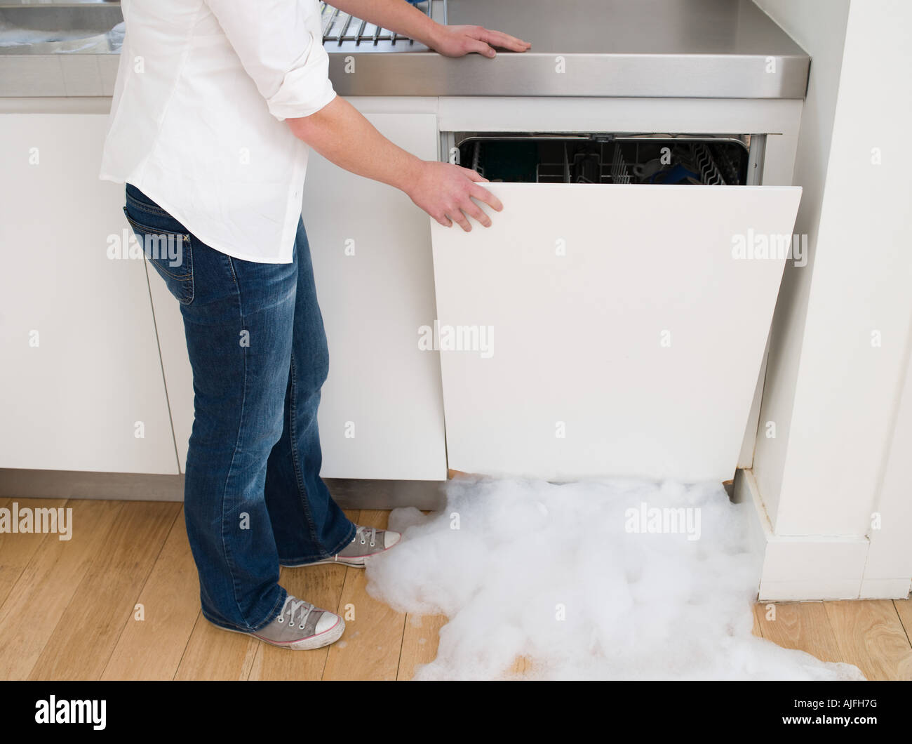 Woman opening a leaking dishwasher Stock Photo Alamy