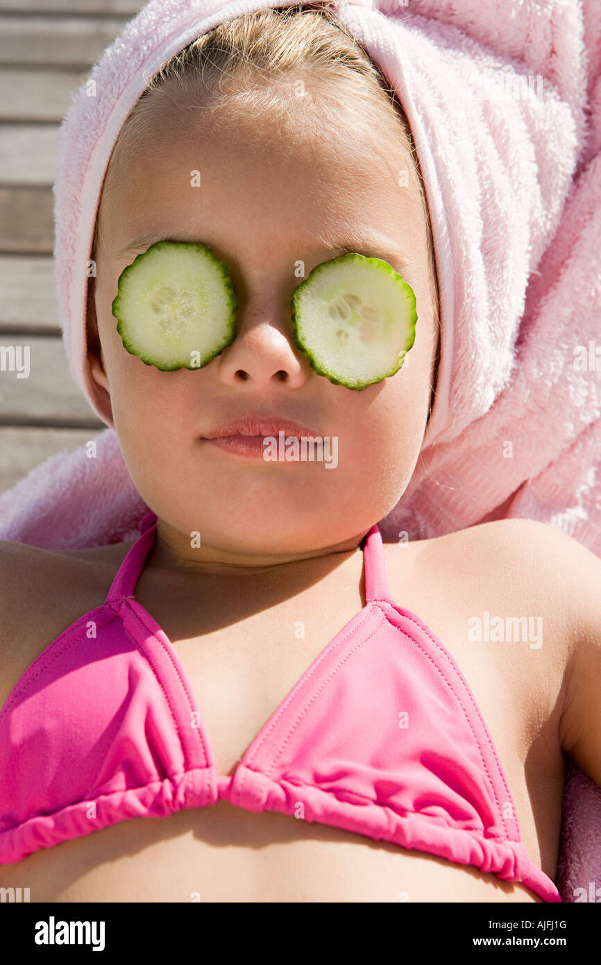 Girl with cucumber slices on her eyes Stock Photo Alamy