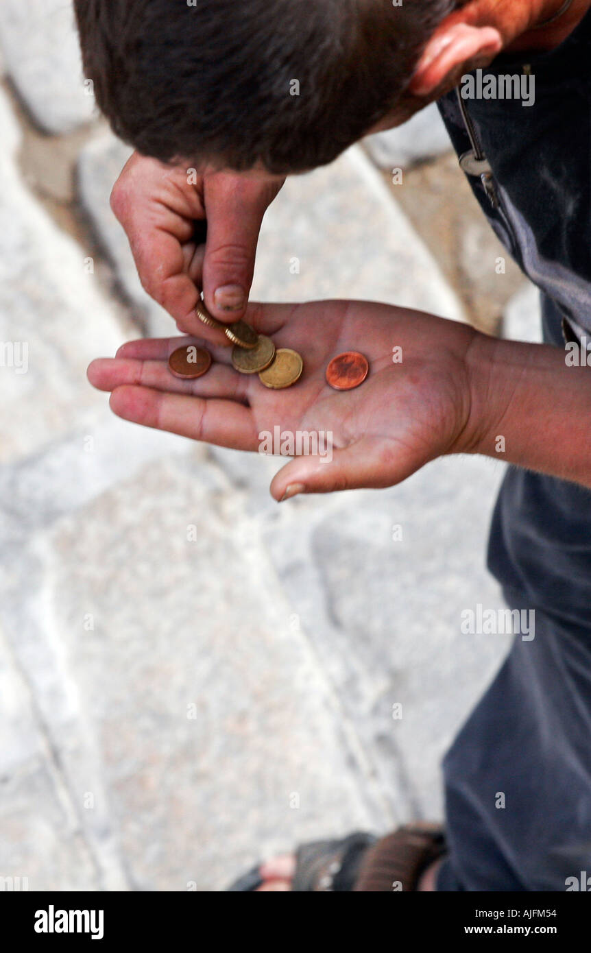 Junky counting coins for his dose Stock Photo