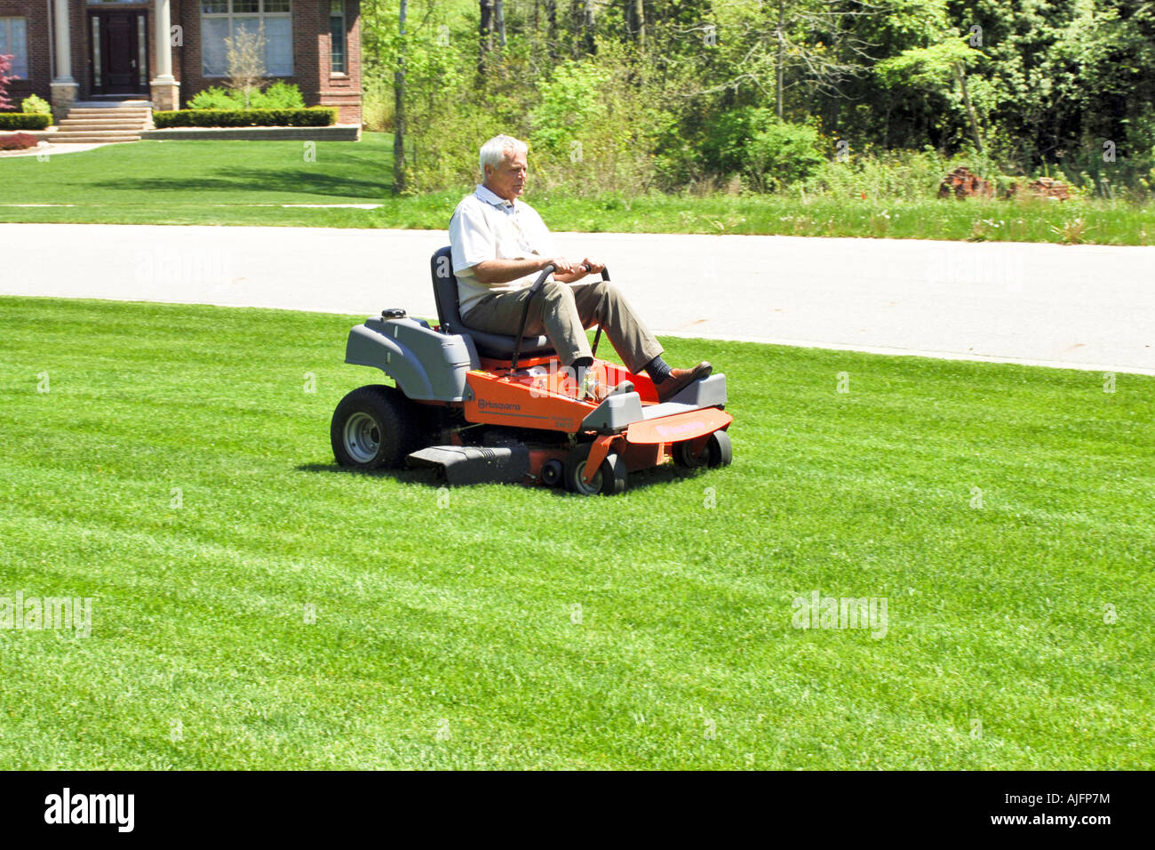 Man sitting on lawn mower hires stock photography and images Alamy