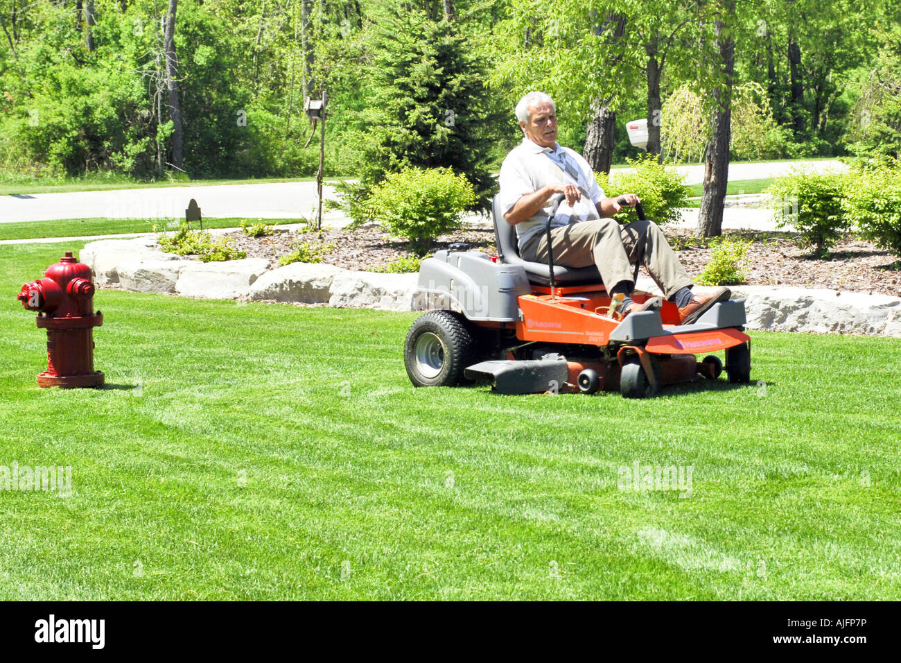 Man sitting on lawn mower hires stock photography and images Alamy