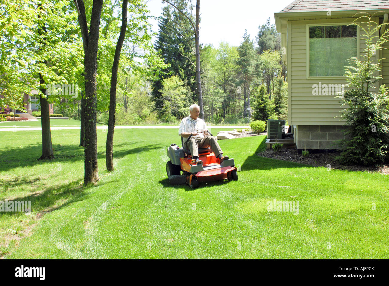 Man sitting on lawn mower hires stock photography and images Alamy