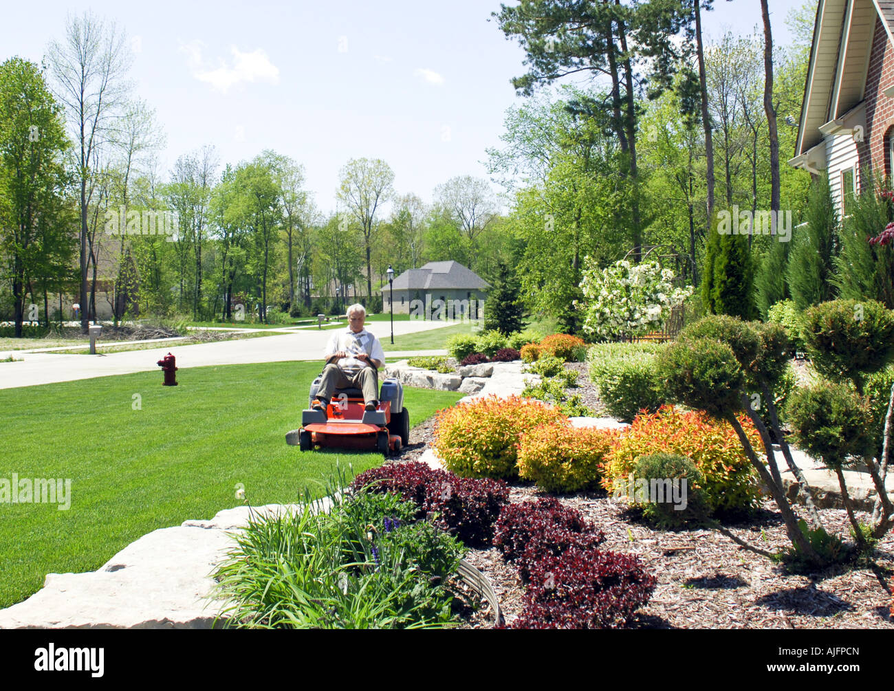Man sitting on lawn mower hires stock photography and images Alamy