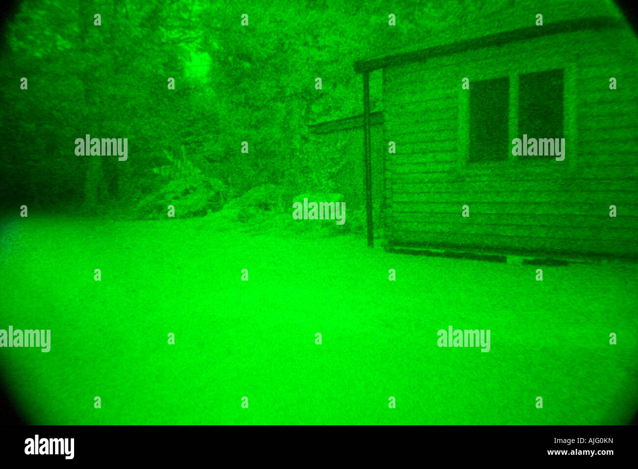 a view through a nightvision scope that uses an image intensifier tube, its a genuine night time photo unlike some others Stock Photo