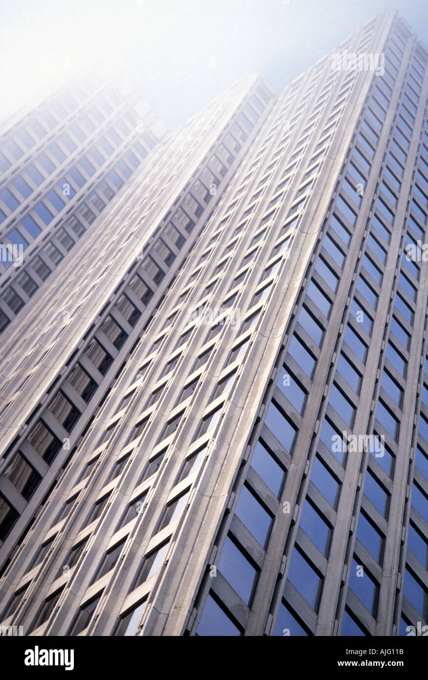 Office tower rising up into the fog Stock Photo