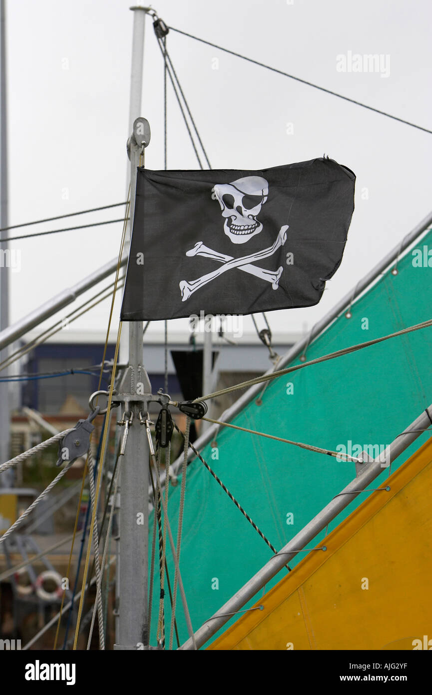 skull and crossbones flag flying from mast of sailing boat berthed in kilkeel harbour county