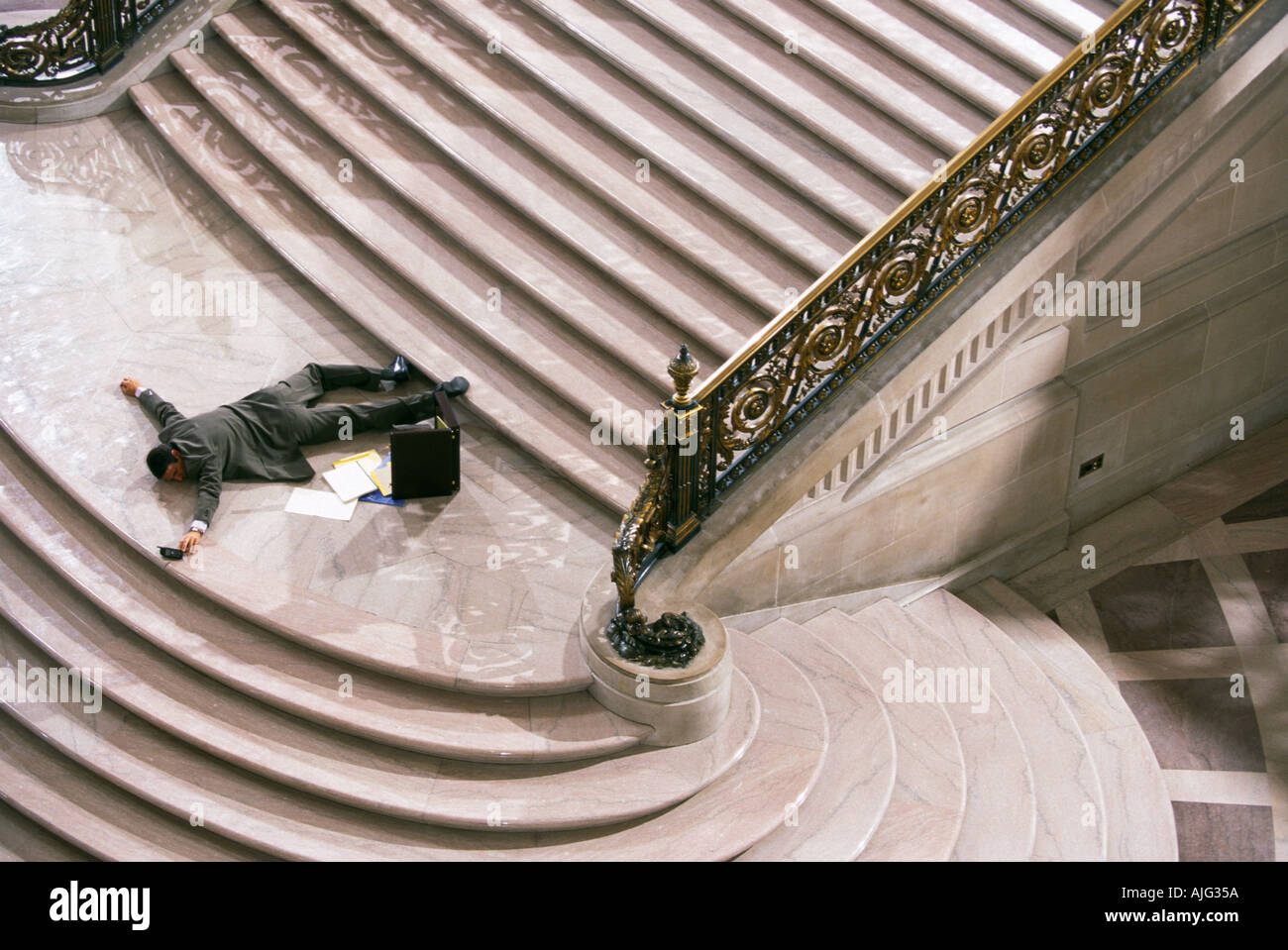 Concept photo of a businessman having fallen down the stairs Stock Photo