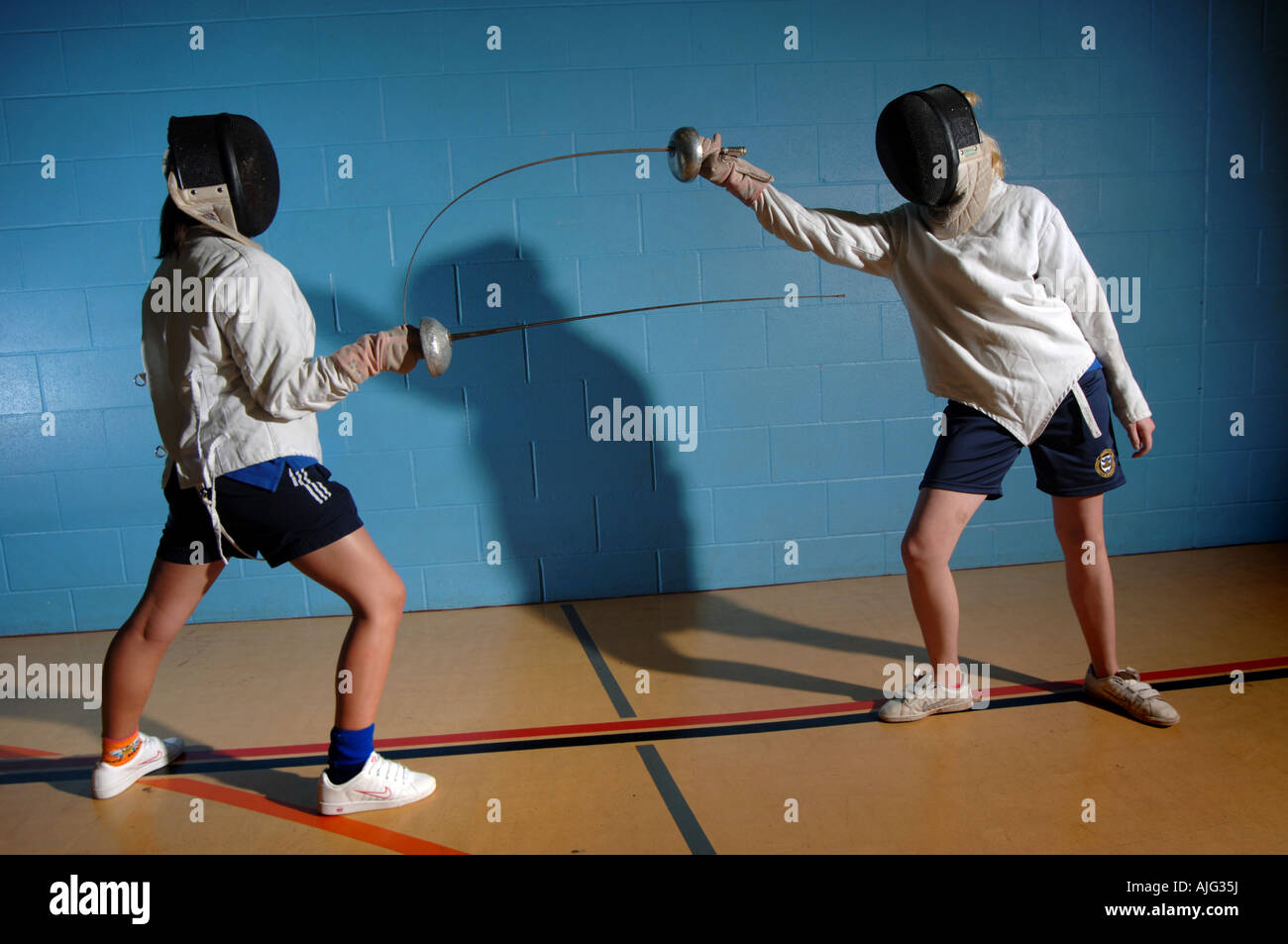 Two girls practising fencing as part of the Body Management Programme Stock Photo