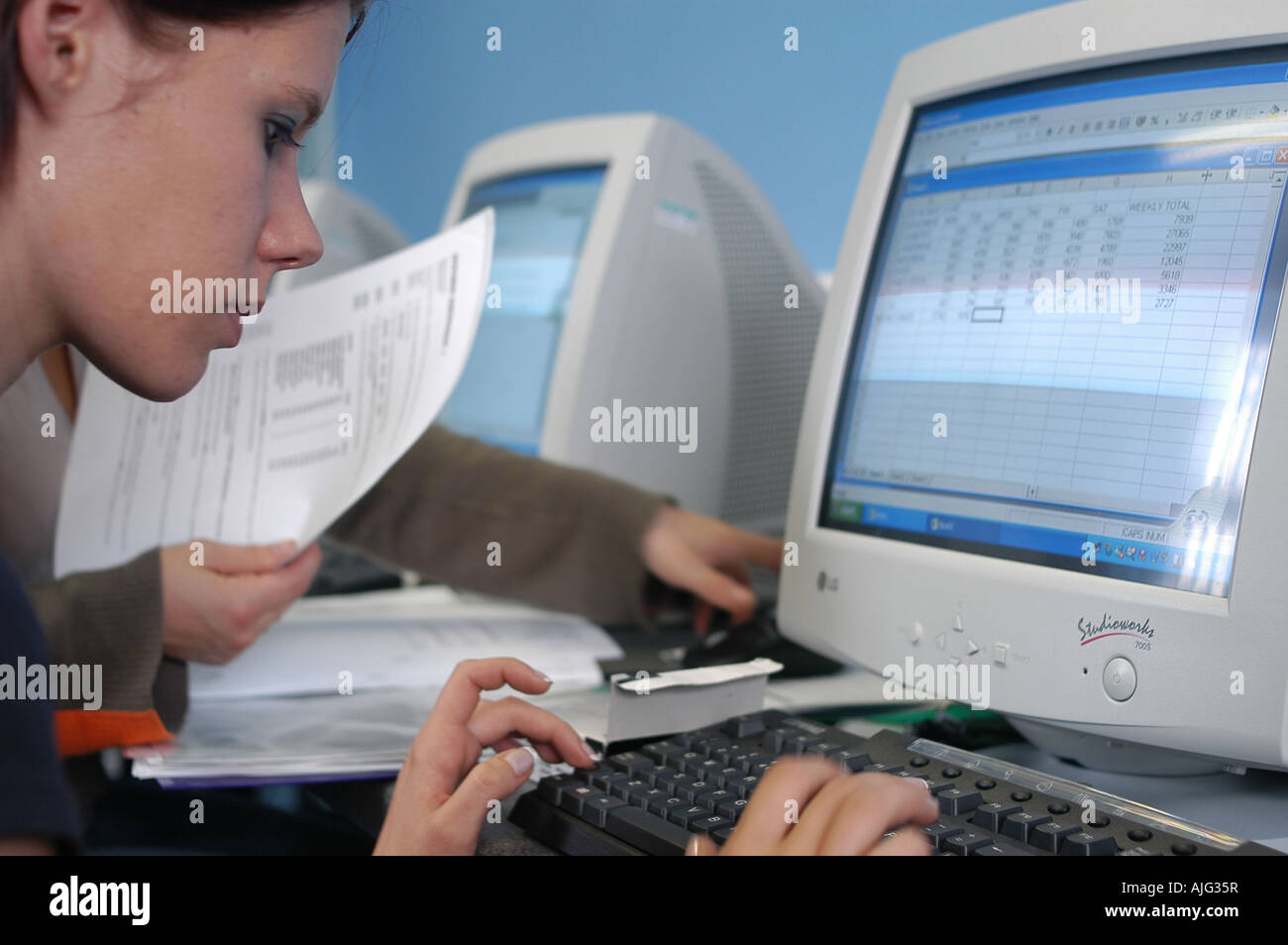 Computer class Girl using keyboard Stock Photo - Alamy