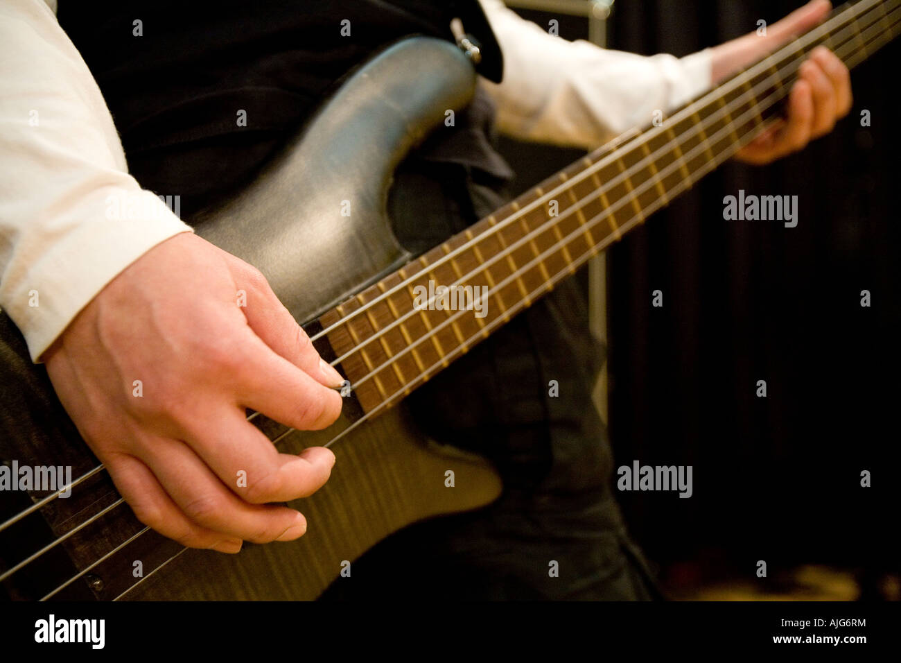 Young man playing bass guitar Stock Photo