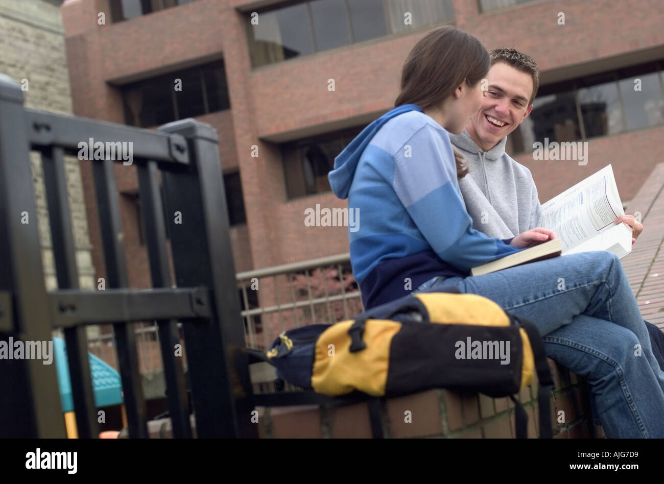 Caucasian college students enjoying each other's company while studying outside Stock Photo