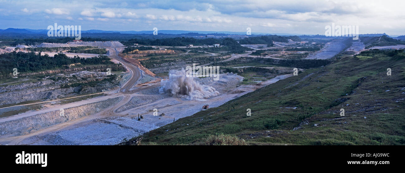 Panorama over opencast surface gold mine showing rock blasting, Ghana, West Africa Stock Photo
