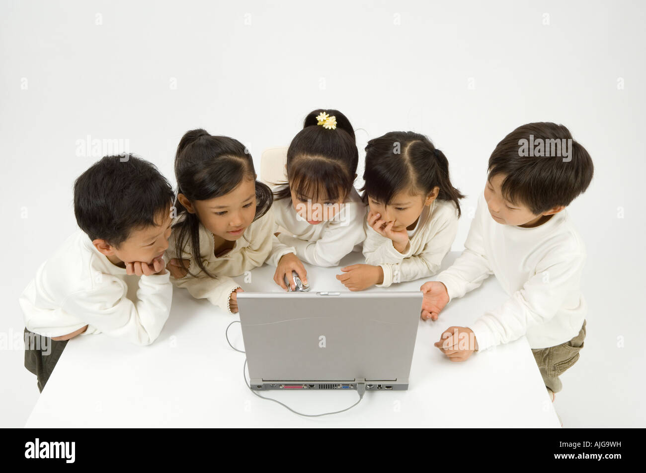 Five elementary age children using laptop Stock Photo - Alamy