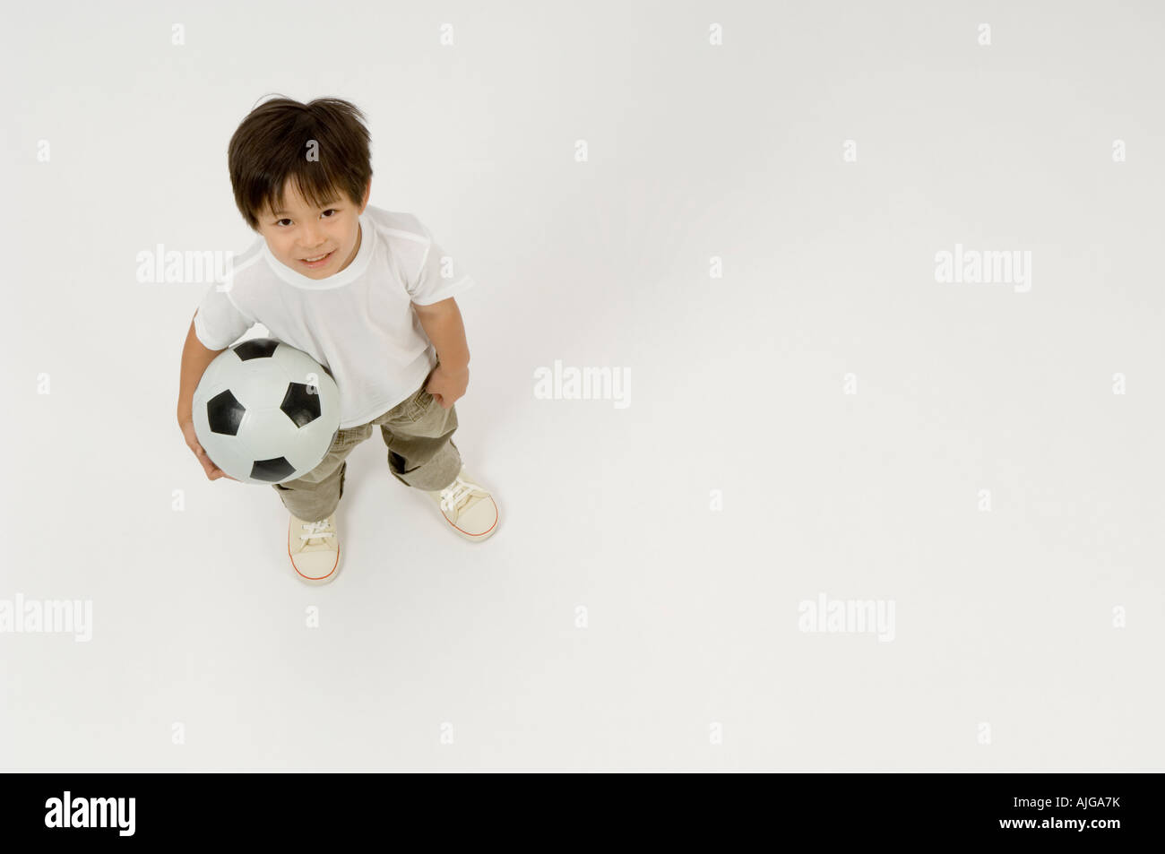Elementary age boy holding soccer ball Stock Photo - Alamy