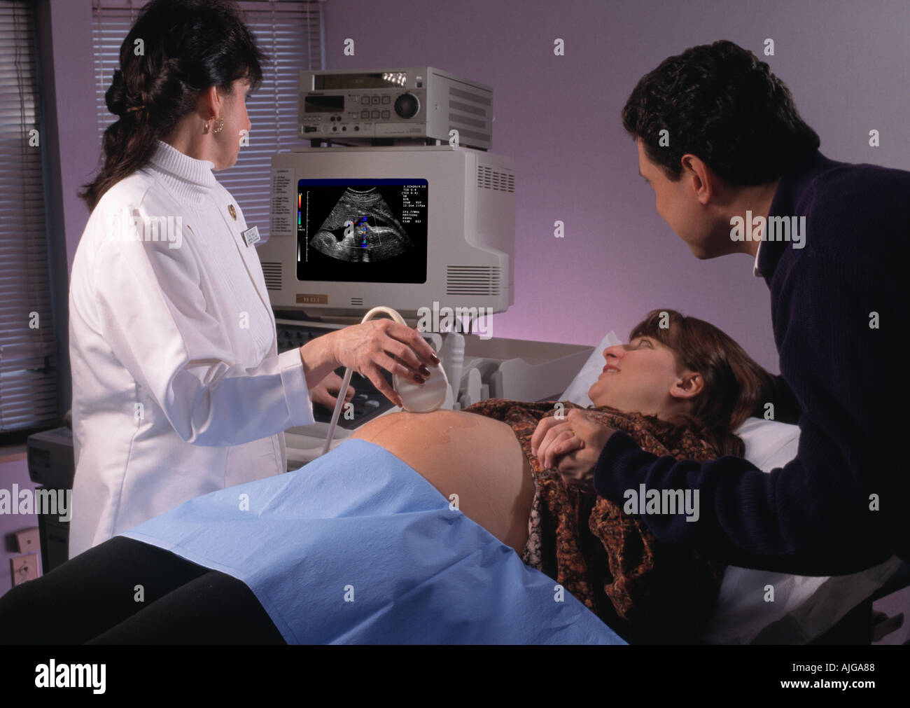 Caucasian pregnant couple viewing an ultrasound image of their unborn baby in the hospital Stock Photo