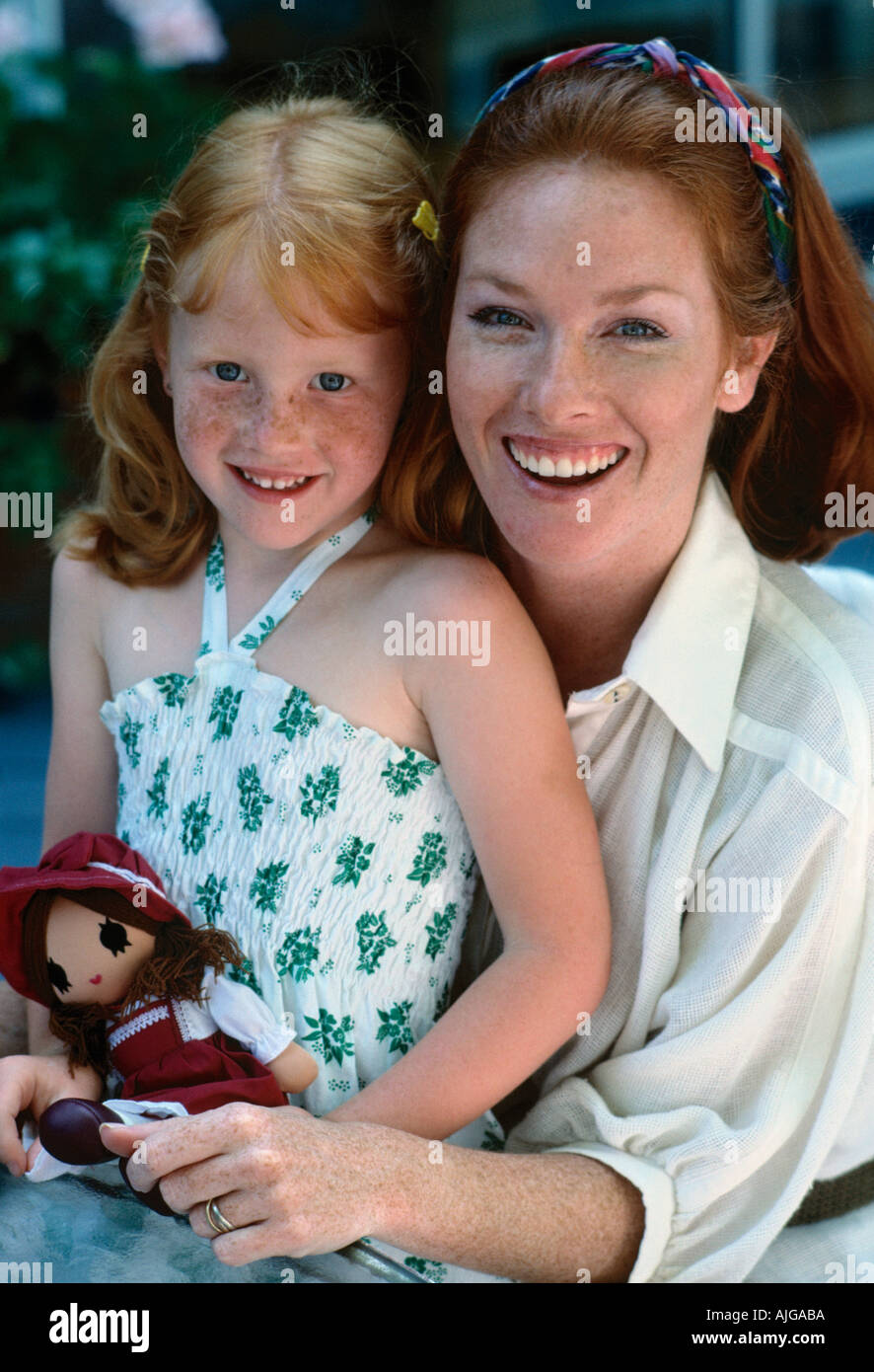 Portrait of a redheaded Caucasian mother with her freckled faceed daughter Stock Photo
