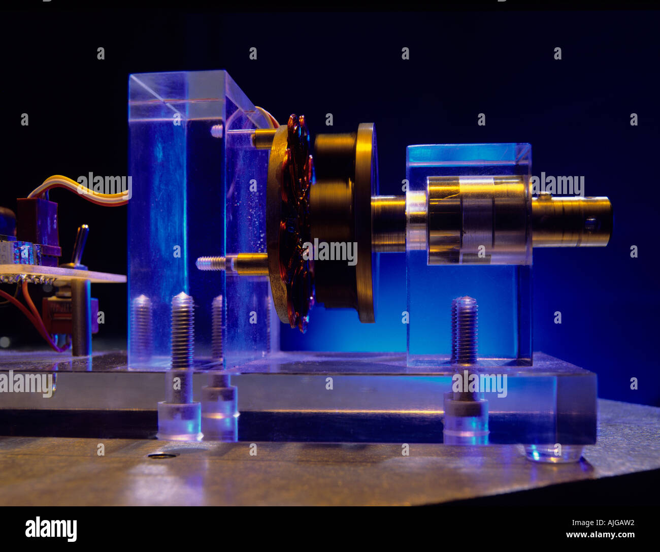 Electric motor turning a spindle demonstrating the principle of