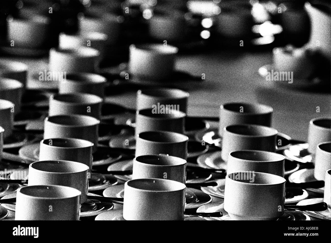 Black and white abstract of full tea cups at UK wedding Stock Photo