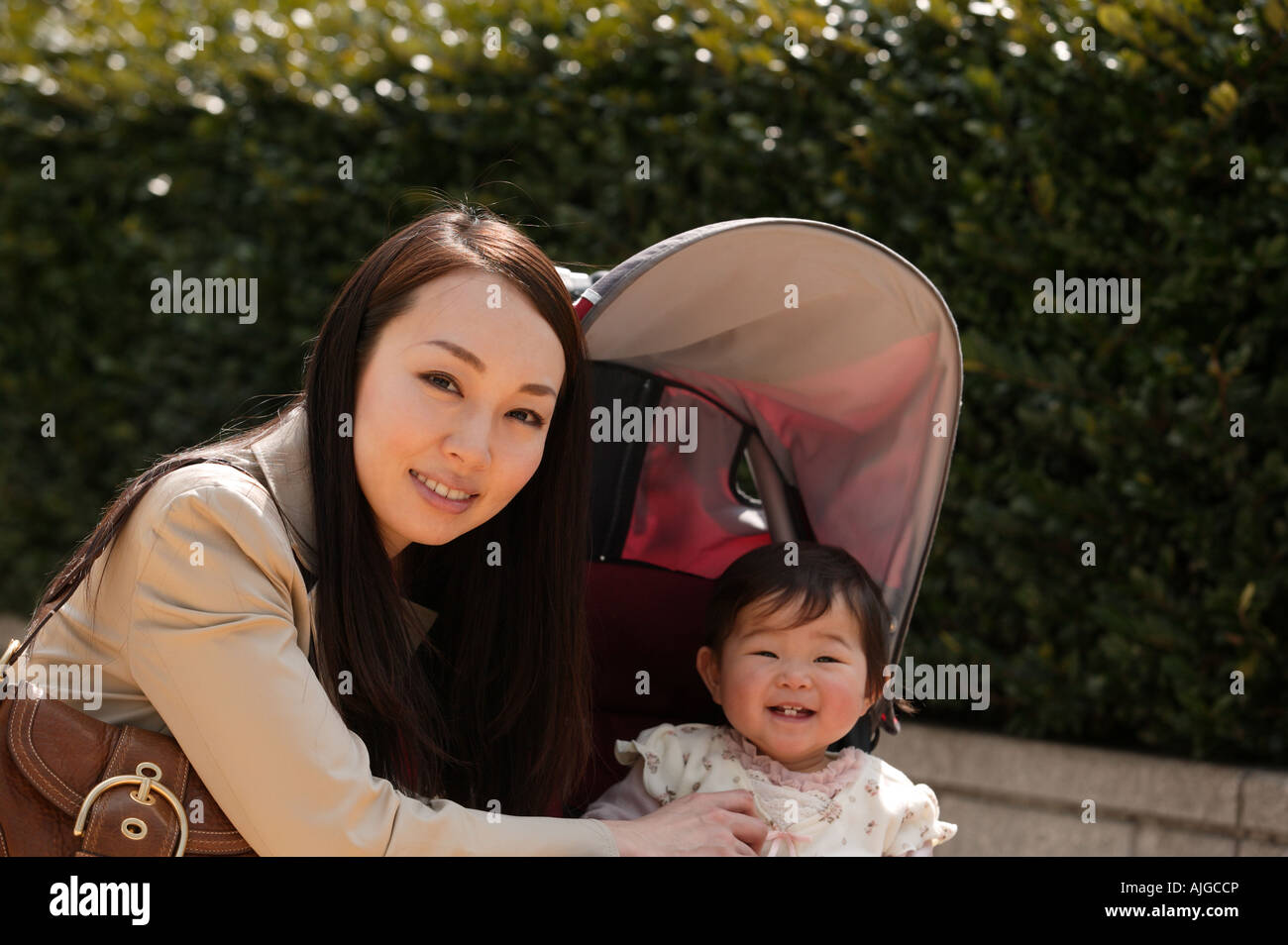 Mother and baby looking at camera Stock Photo - Alamy