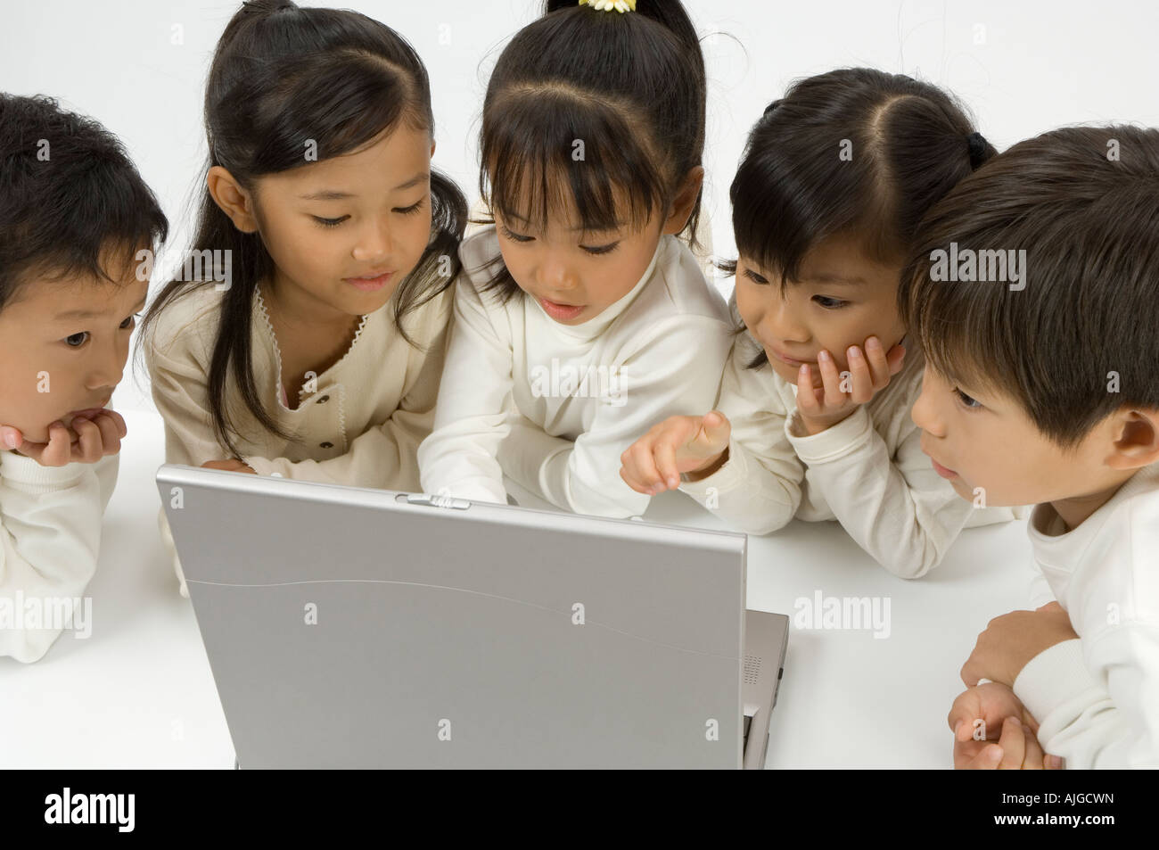 Five elementary age children using laptop Stock Photo - Alamy